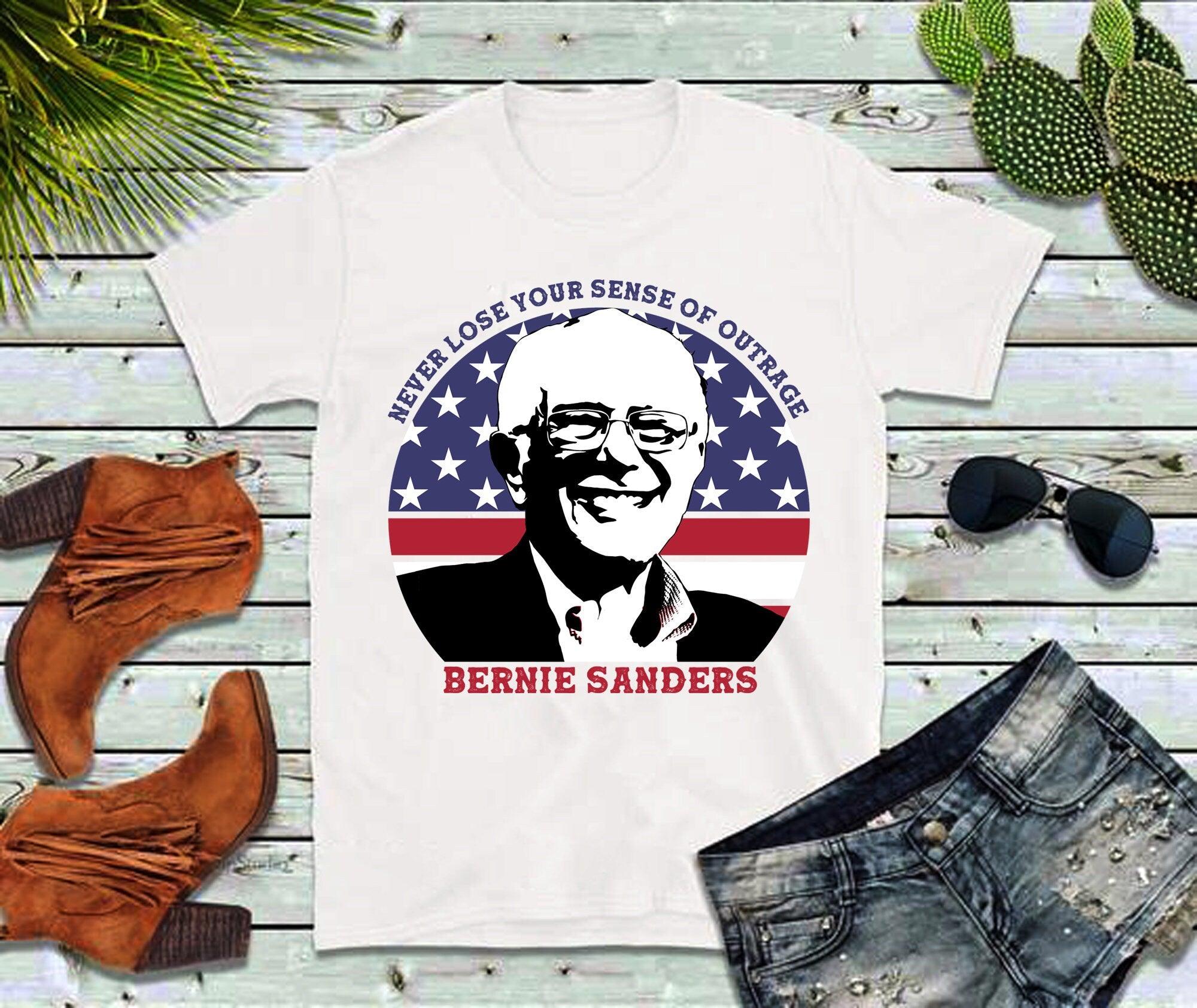 Never Lose Your Sense Of Outrage | Bernie Sanders | Circle American Flag T-Shirts bernie sanders, bernie sanders 2021, bernie sanders gift, bernie sanders shirt, bernie shirt, bernie tshirt, democrat shirt, inauguration 2021, inauguration day, inauguration shirt, political shirt, politics shirt, sanders inauguration - plusminusco.com